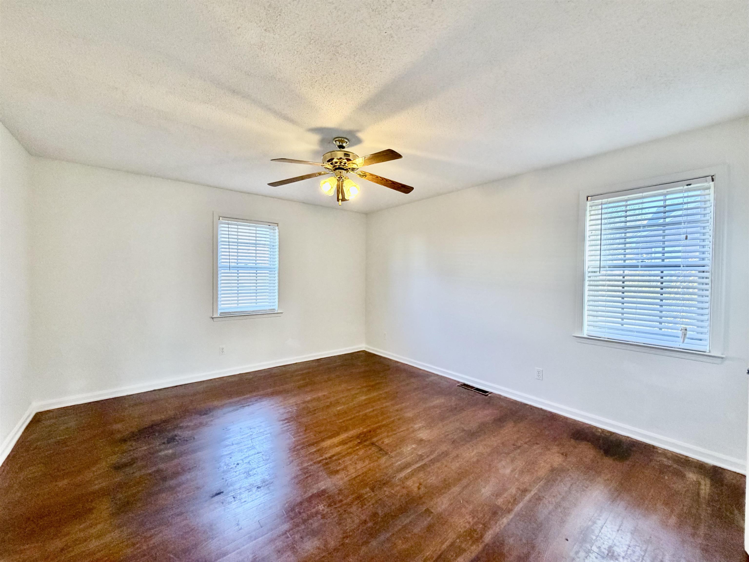 3179 Coleman Road Memphis, TN 38128 - Photo 13 of 22 an empty room with wooden floor fan and windows