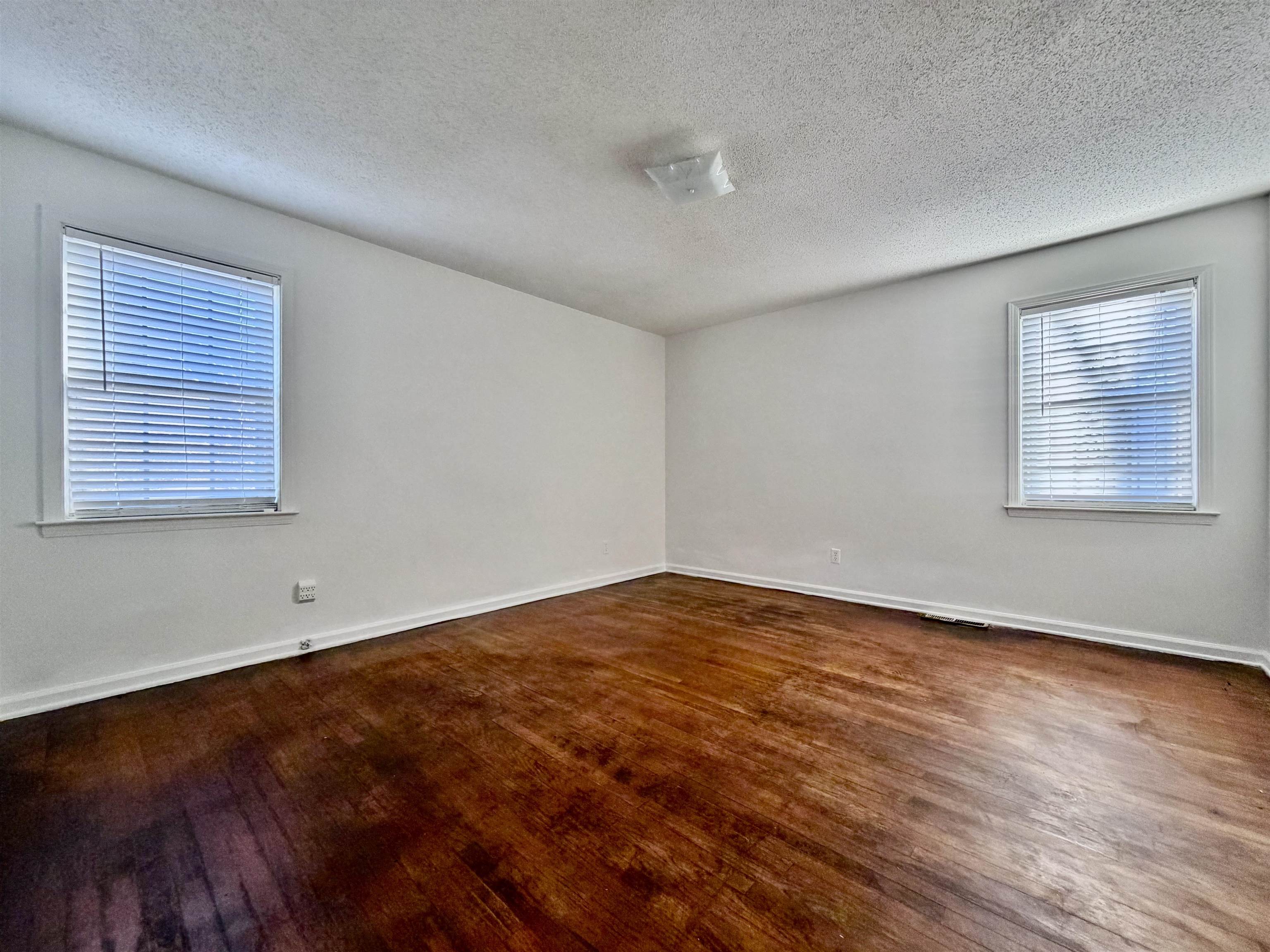 3179 Coleman Road Memphis, TN 38128 - Photo 14 of 22 an empty room with wooden floor and windows