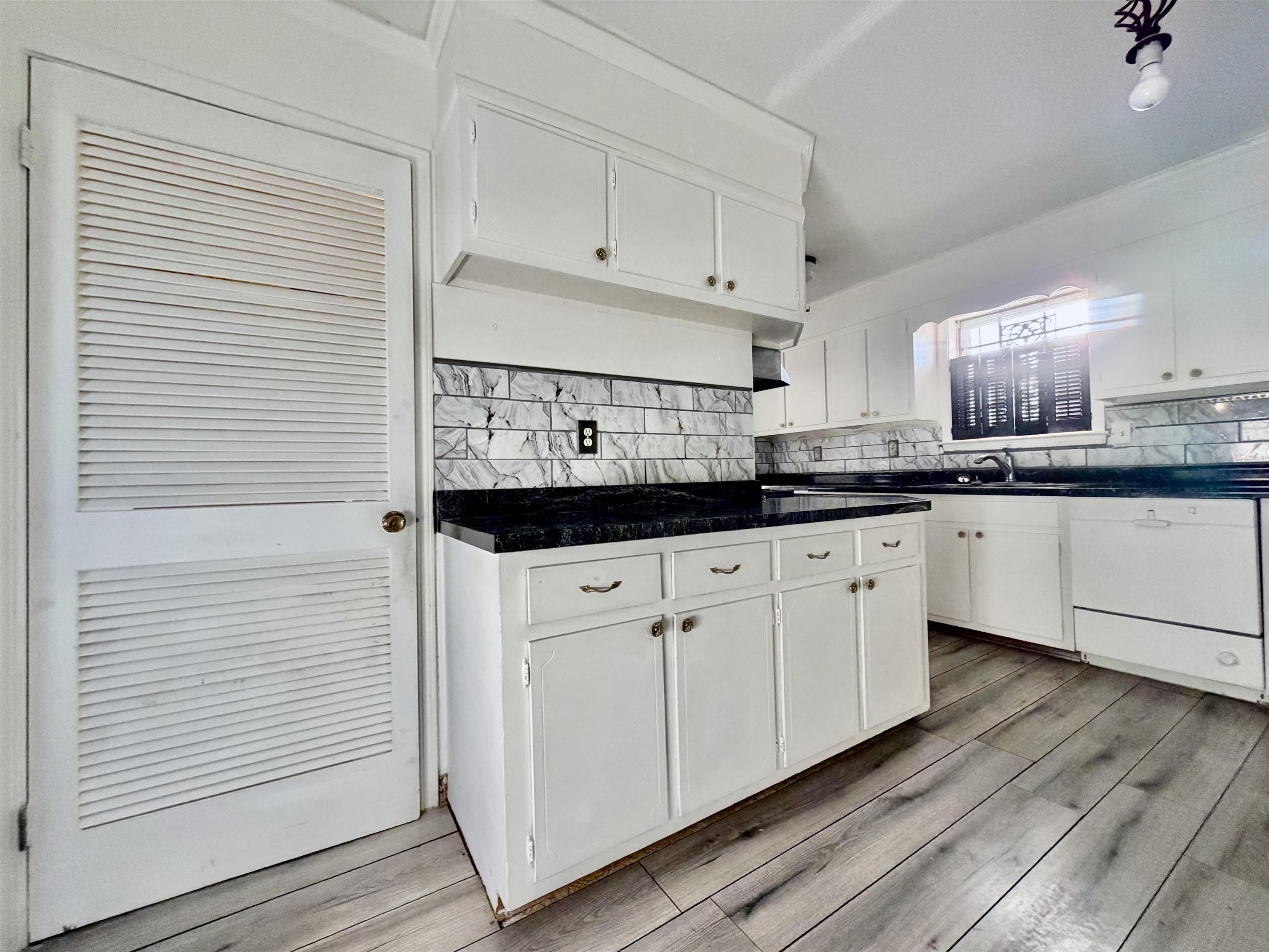 3179 Coleman Road Memphis, TN 38128 - Photo 18 of 22 a kitchen with stainless steel appliances granite countertop white cabinets sink and dishwasher