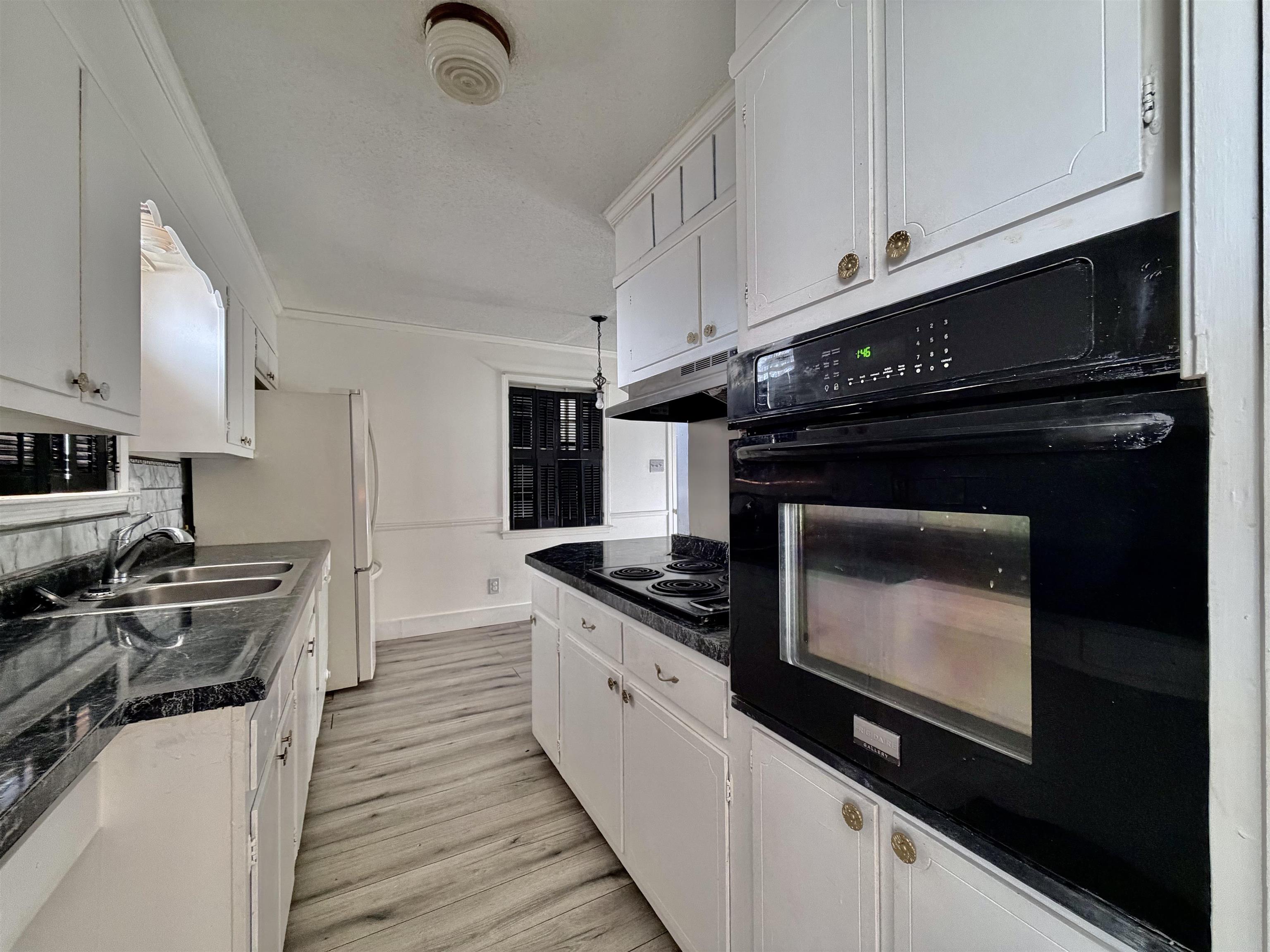 3179 Coleman Road Memphis, TN 38128 - Photo 21 of 22 a kitchen with stainless steel appliances granite countertop a stove a sink and a microwave