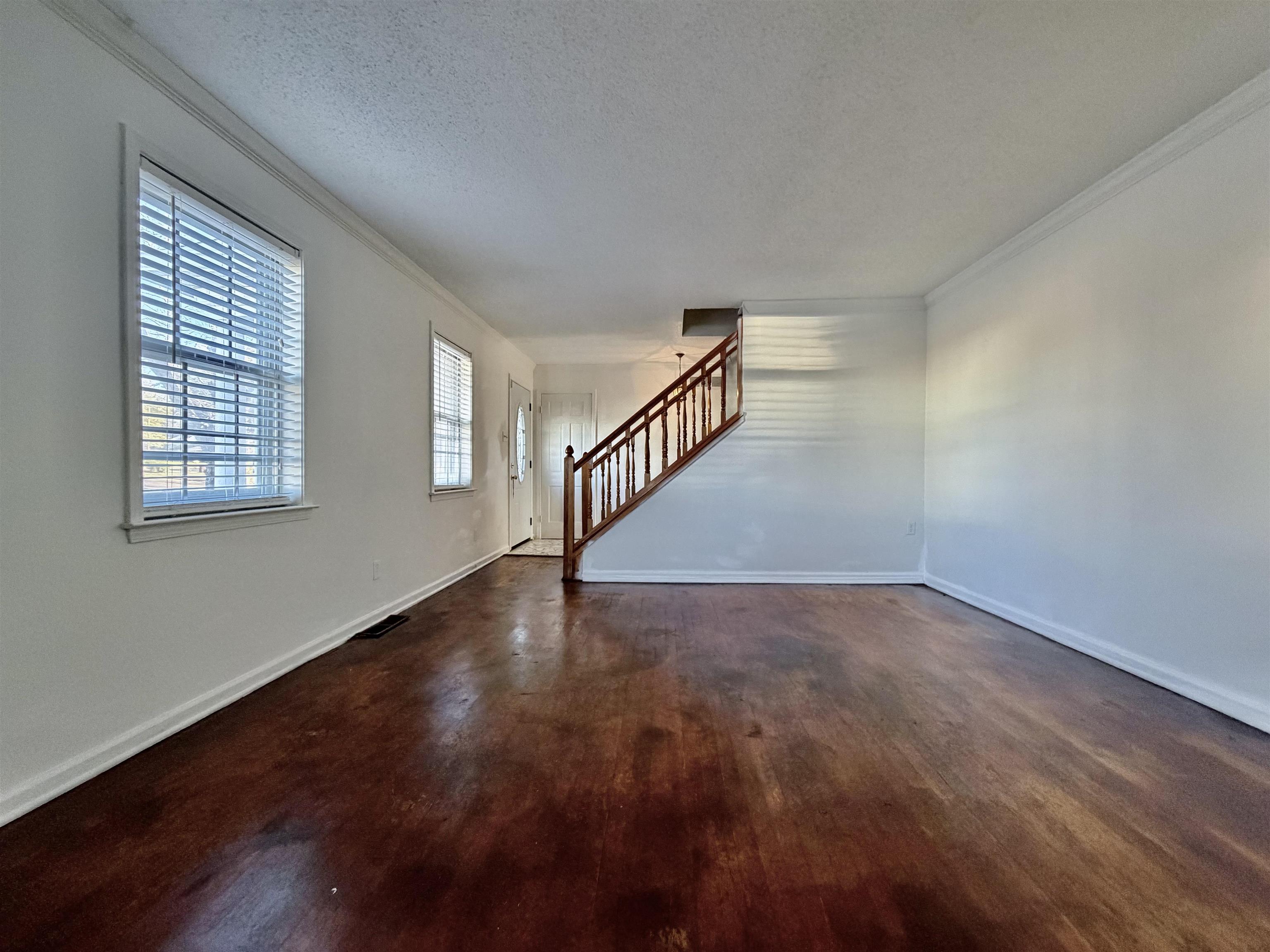3179 Coleman Road Memphis, TN 38128 - Photo 10 of 22 a view of an empty room with wooden floor and a window