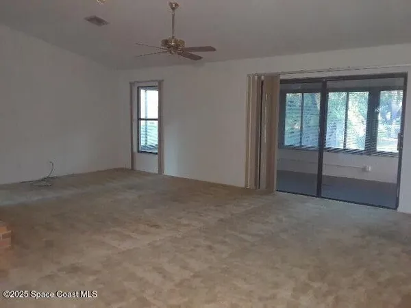 a view of an empty room with a window