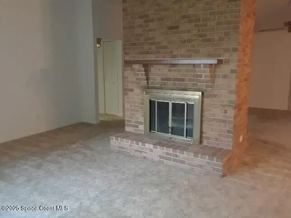 a view of empty room with a fireplace