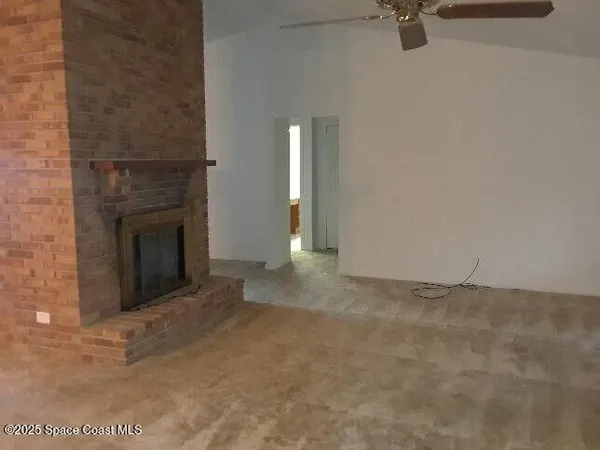 a view of an empty room with a fireplace