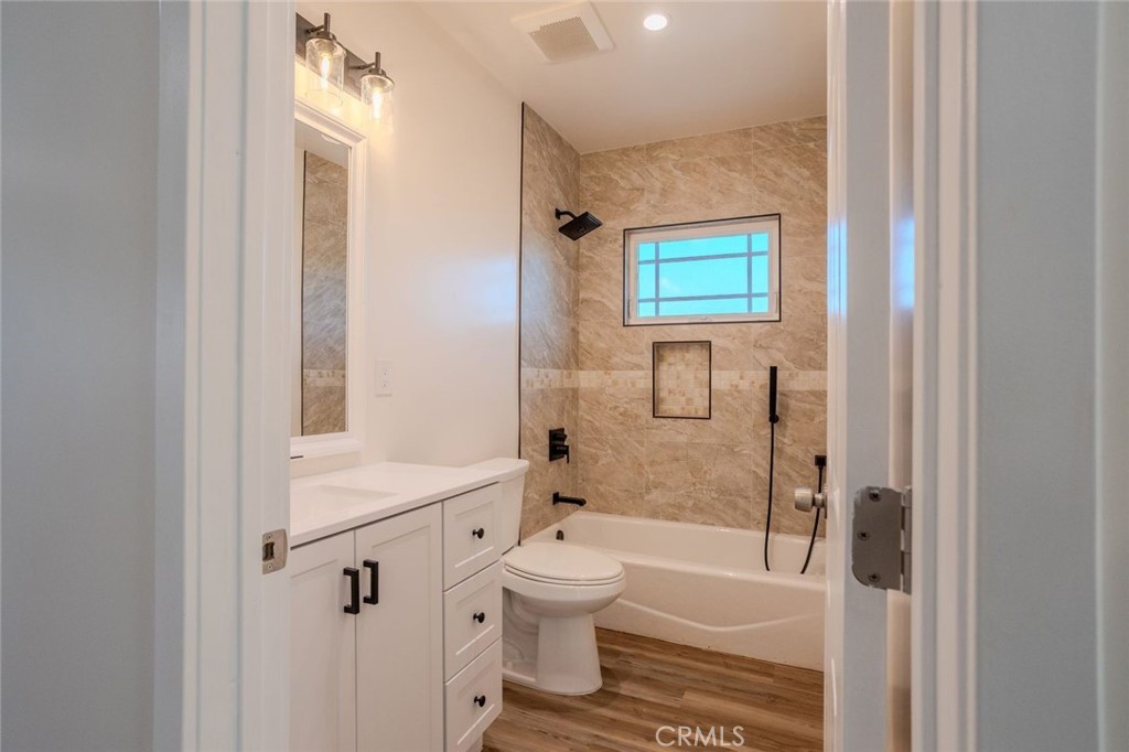 345 West 3rd Street, Unit A San Dimas, CA 91773 - Photo 11 of 12 a bathroom with a bathtub shower sink vanity and a toilet