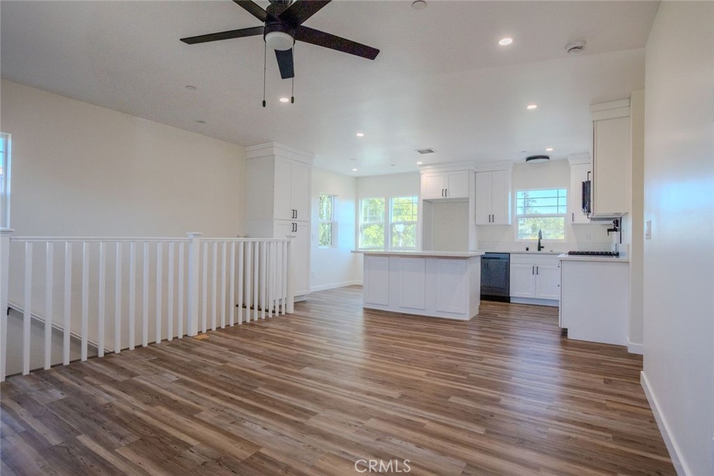 345 West 3rd Street, Unit A San Dimas, CA 91773 - Photo 2 of 12 a view of an empty room and kitchen with wooden floor