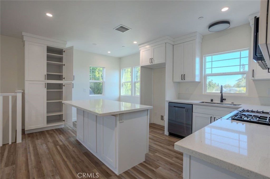 345 West 3rd Street, Unit A San Dimas, CA 91773 - Photo 5 of 12 a kitchen with stainless steel appliances granite countertop a stove a refrigerator and a white cabinets with wooden floor