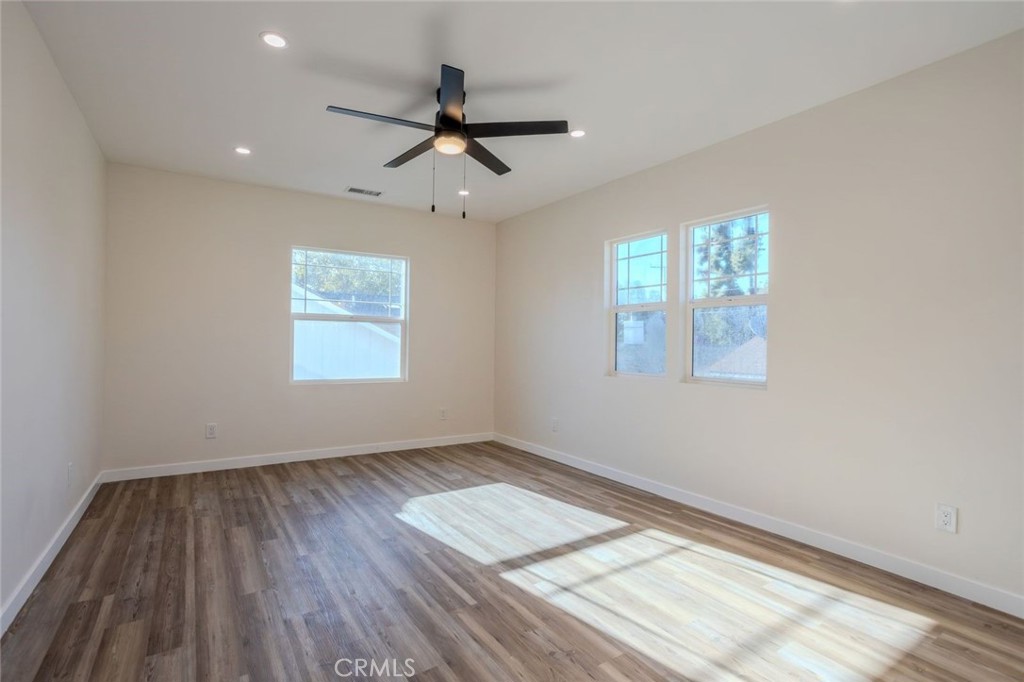 345 West 3rd Street, Unit A San Dimas, CA 91773 - Photo 7 of 12 a view of empty room with wooden floor and fan