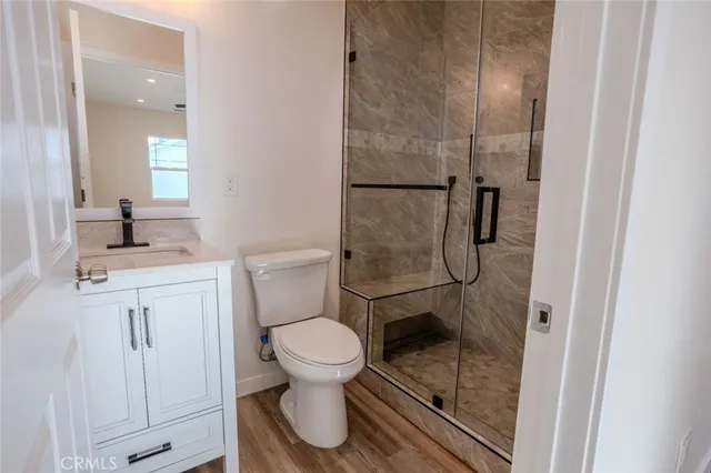a bathroom with a granite countertop toilet sink and shower