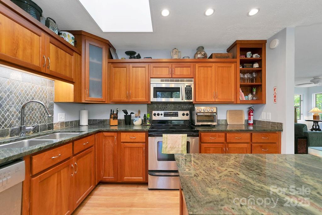 109 Rocky Hill Overlook Road Brevard, NC 28712 - Photo 17 of 41 a large kitchen with stainless steel appliances granite countertop a stove sink and cabinets