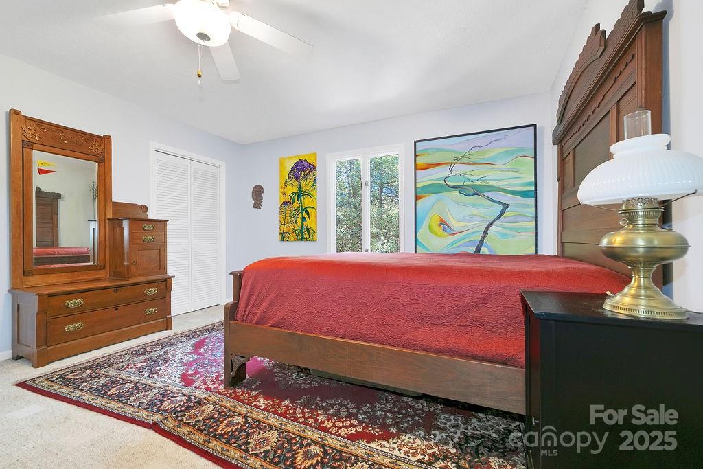 109 Rocky Hill Overlook Road Brevard, NC 28712 - Photo 29 of 41 a bedroom with a bed dresser and a window