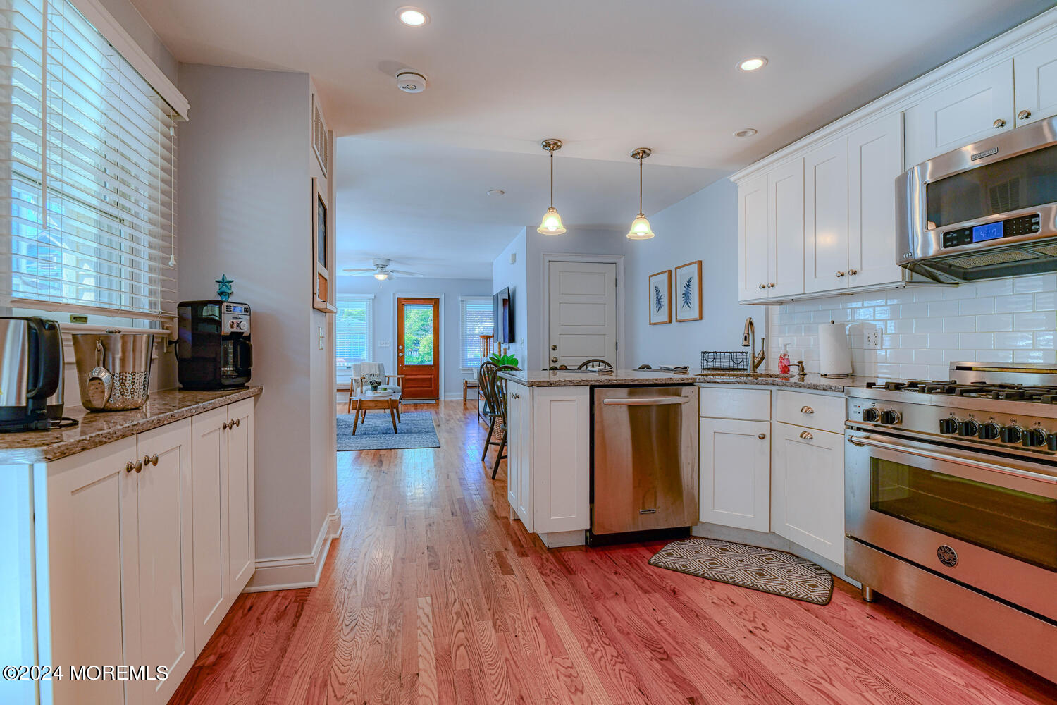 94 Clark Avenue Ocean Grove, NJ 07756 - Photo 13 of 29 a kitchen with stove cabinets and wooden floor
