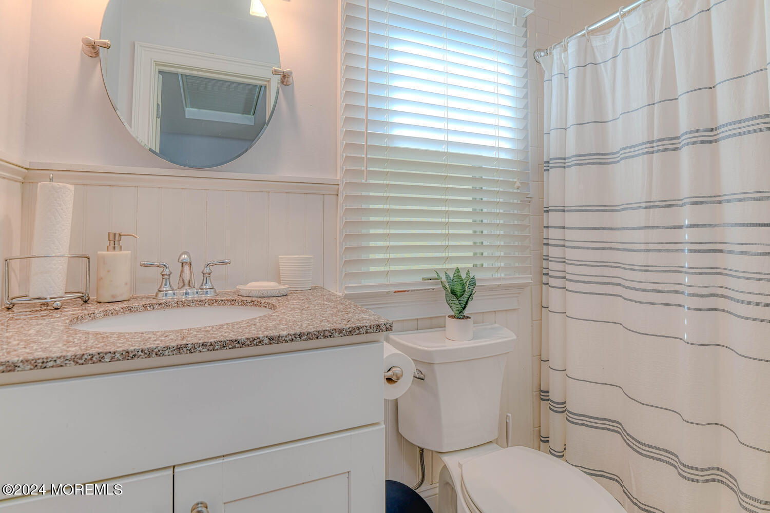 94 Clark Avenue Ocean Grove, NJ 07756 - Photo 17 of 29 a bathroom with a granite countertop toilet sink and mirror
