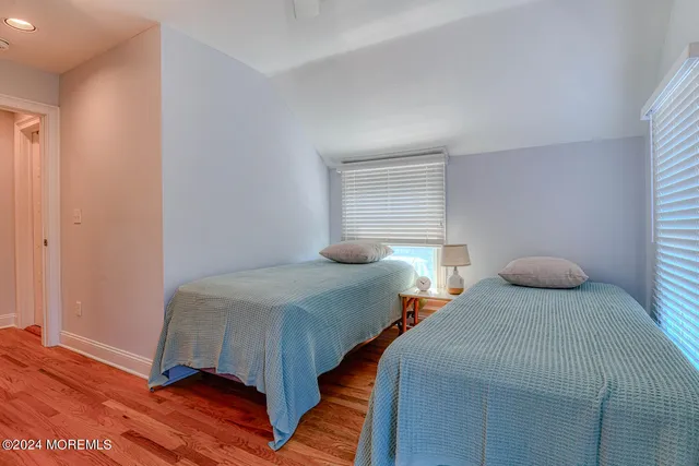 a bedroom with two beds and a window