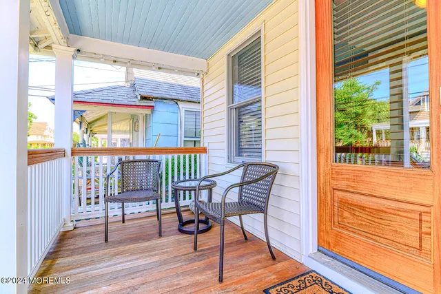 a balcony with table and chairs