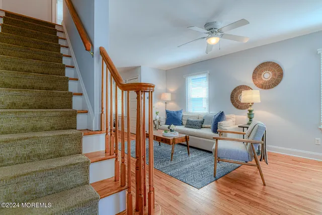 a living room with couches chairs and closet with wooden floor