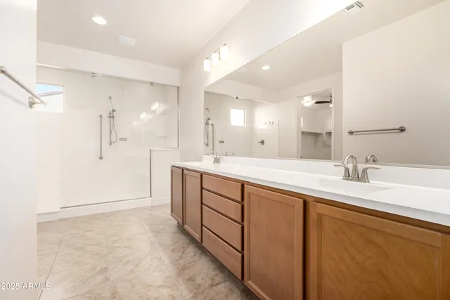 a large bathroom with a granite countertop sink mirror and a