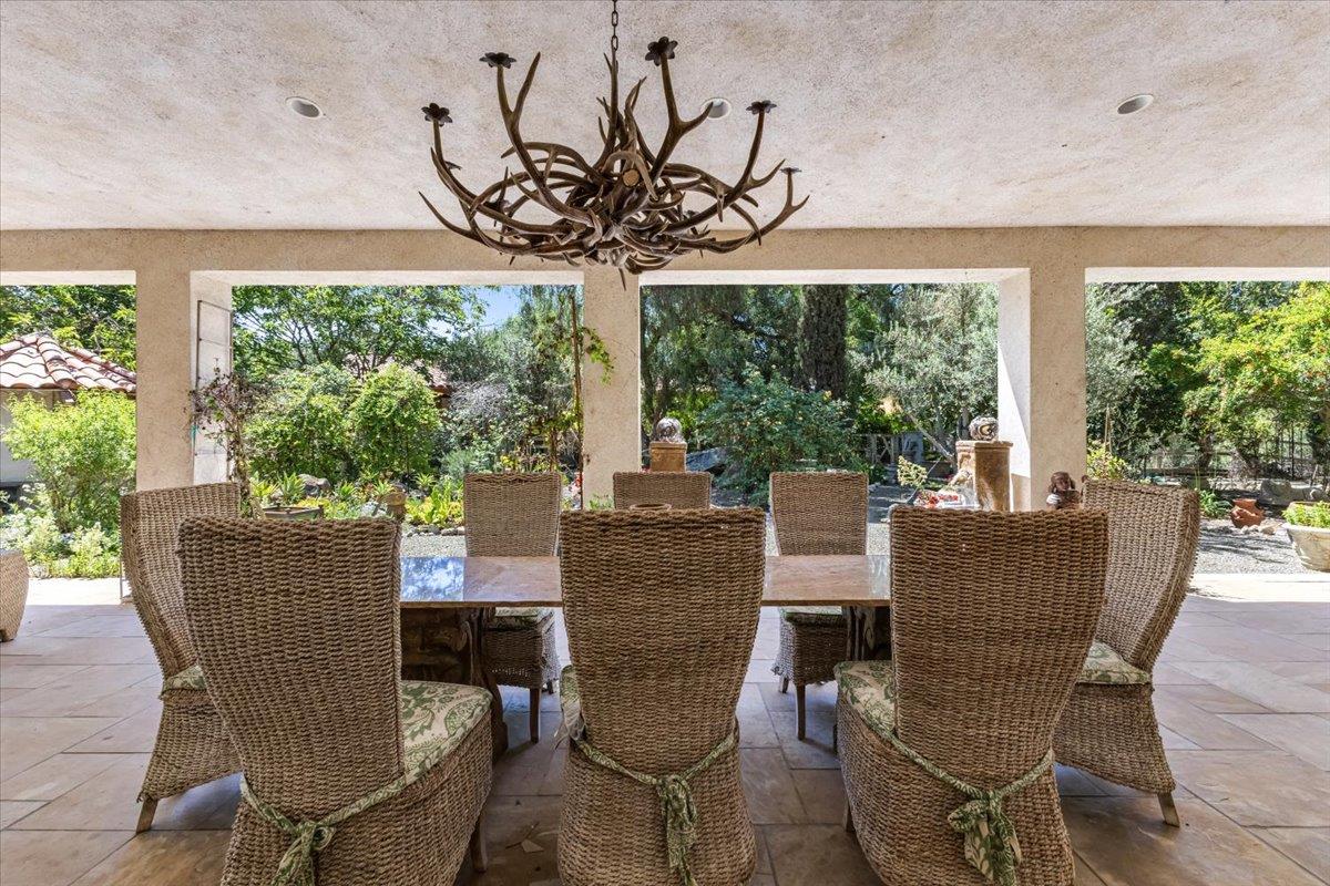 2727 Thomas Road Hollister, CA 95023 - Photo 36 of 83 a view of a dining room with furniture a chandelier and large windows