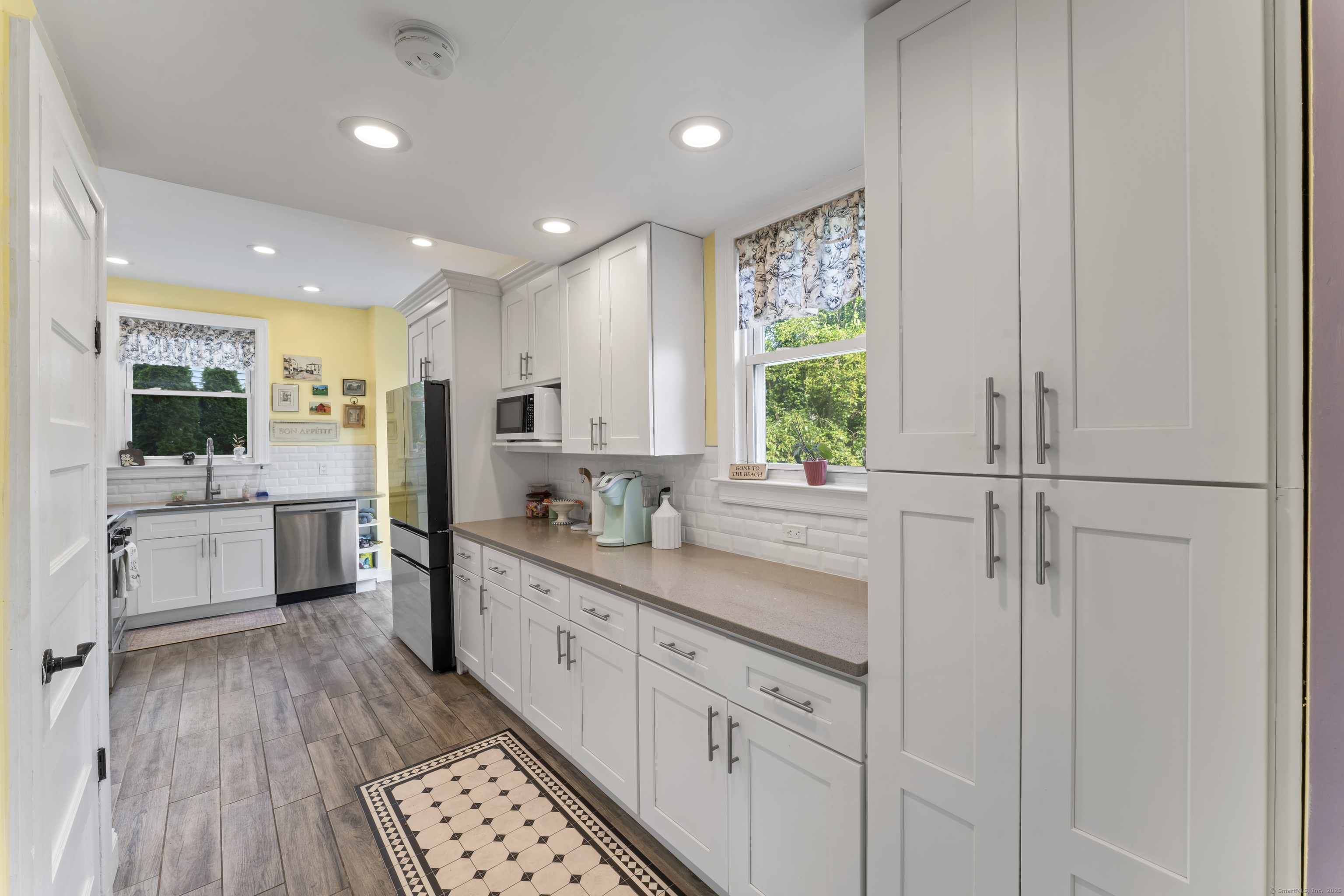82 Main Street West Haven, CT 06516 - Photo 13 of 40 a kitchen with white cabinets and white appliances