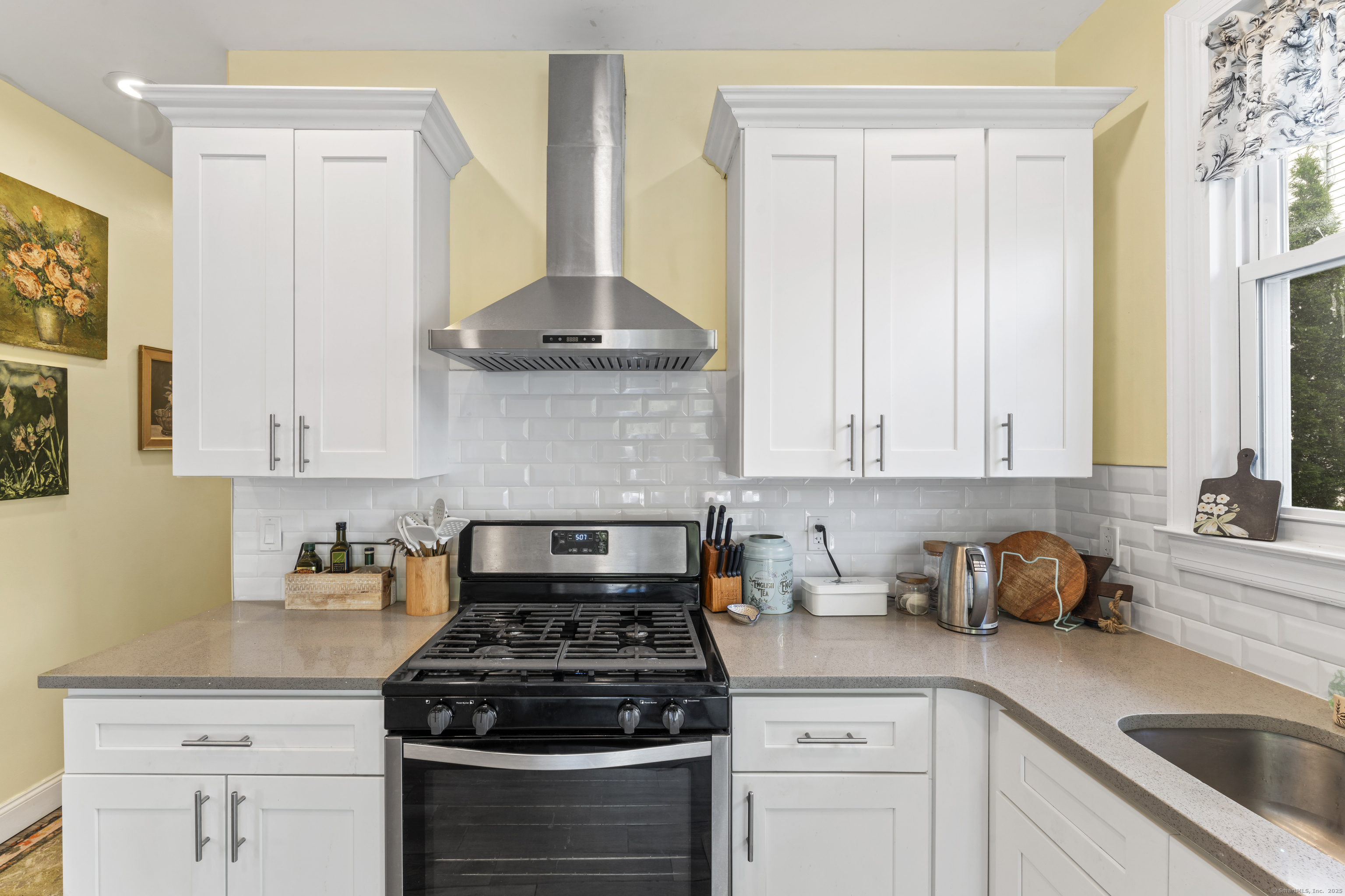 82 Main Street West Haven, CT 06516 - Photo 15 of 40 a kitchen with stainless steel appliances granite countertop a stove a sink and a white cabinets