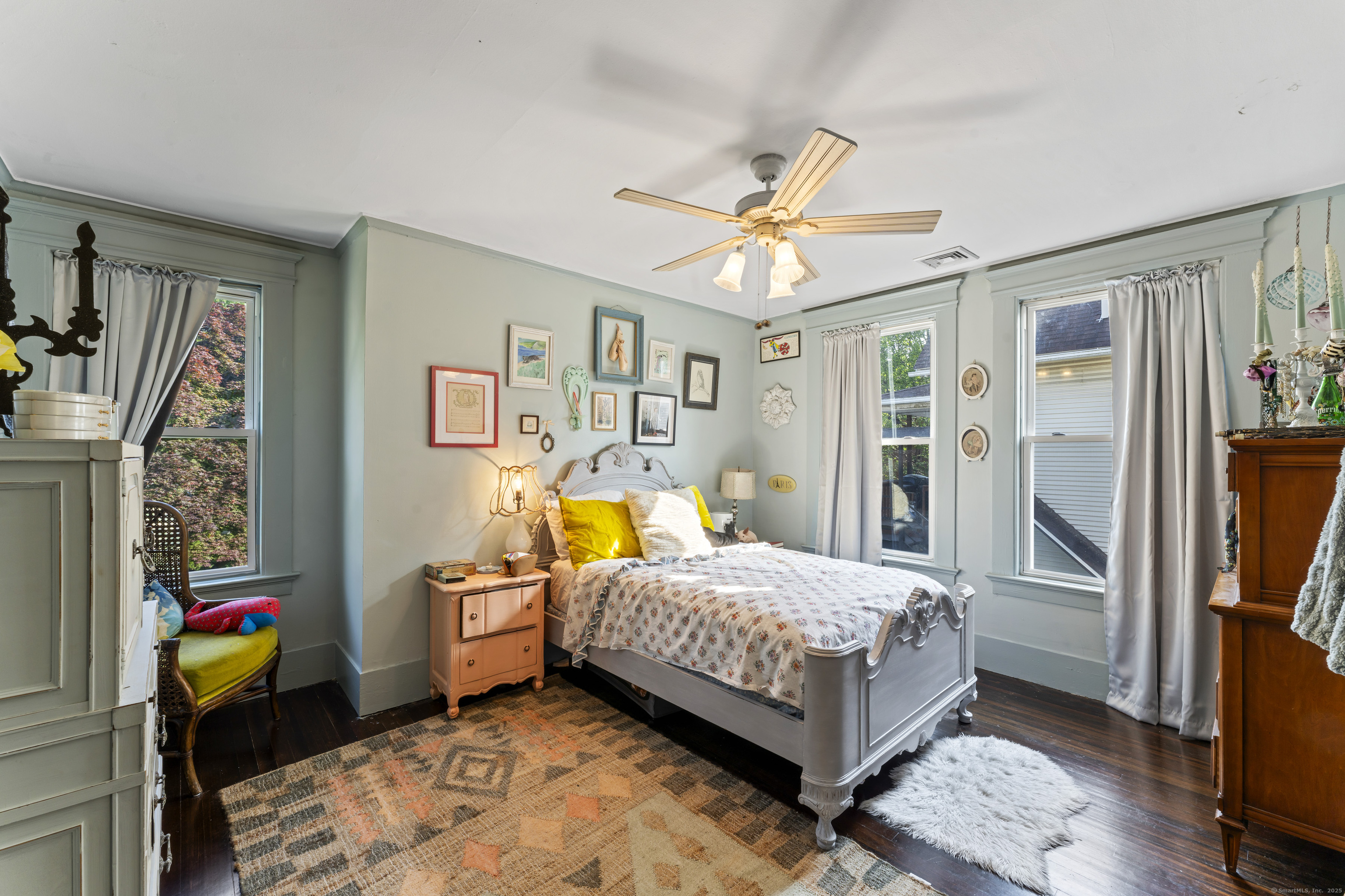 82 Main Street West Haven, CT 06516 - Photo 21 of 40 a bedroom with a bed and wooden floor