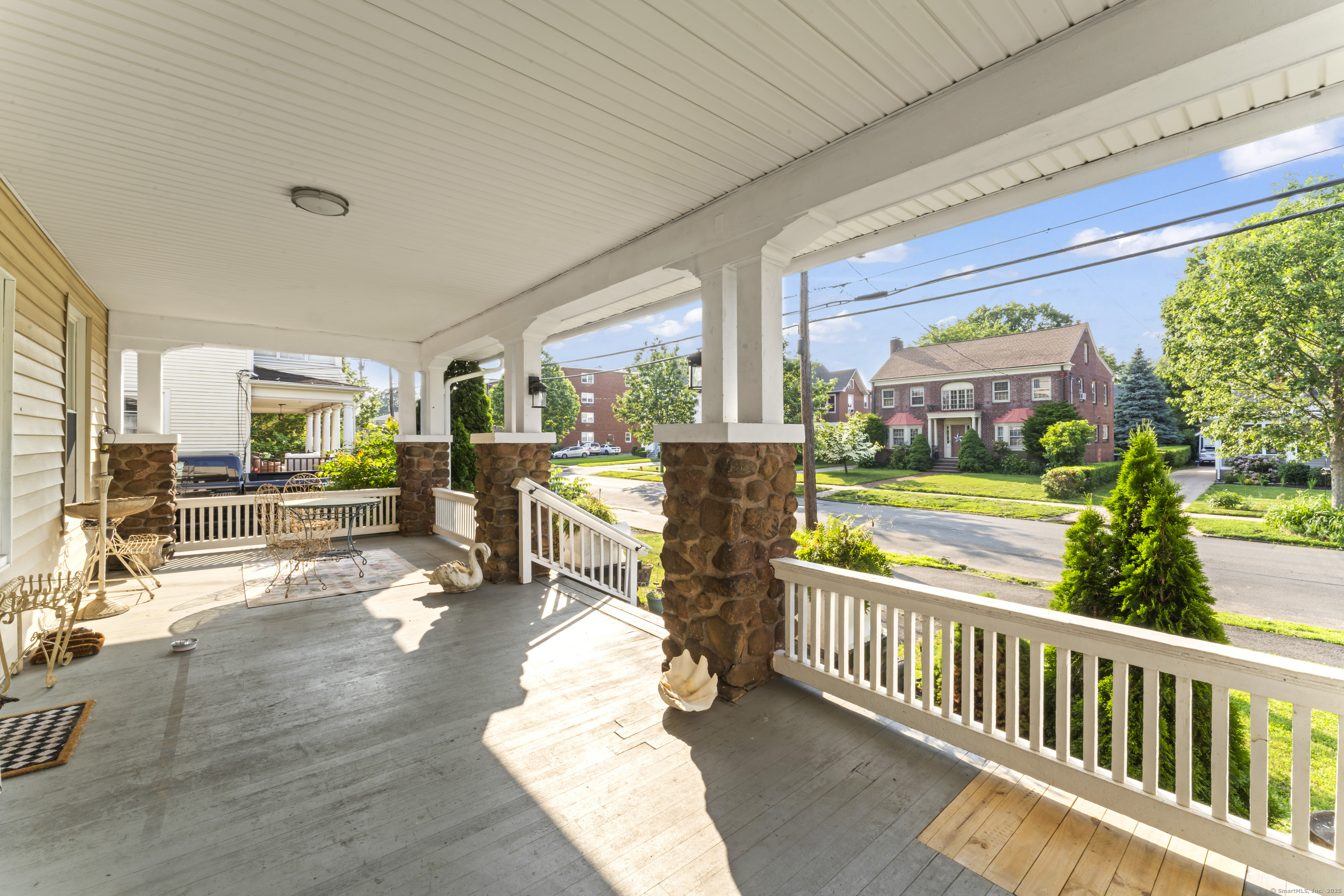82 Main Street West Haven, CT 06516 - Photo 5 of 40 a view of a porch with chairs and couches with wooden floor