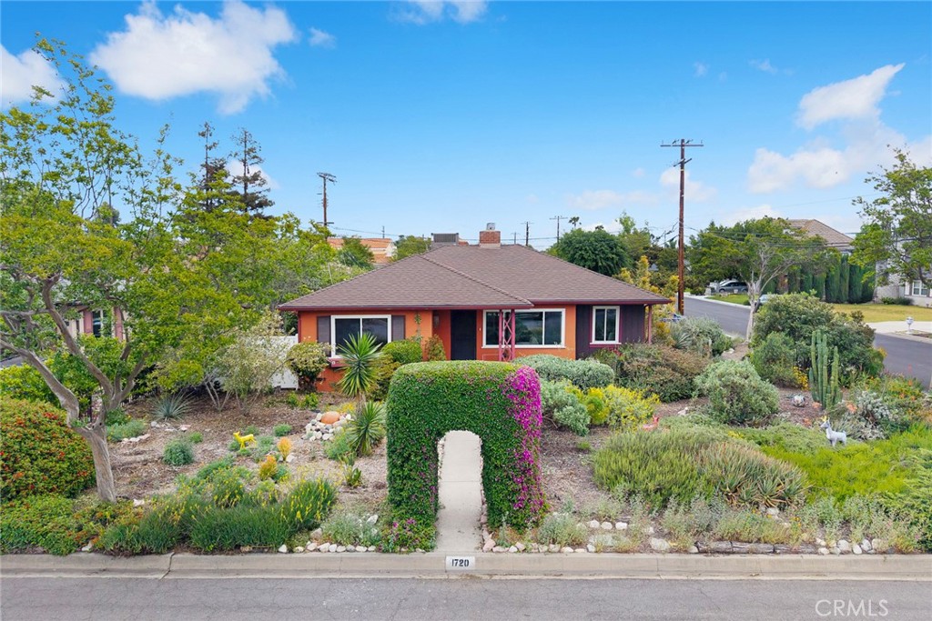 a front view of a house with garden