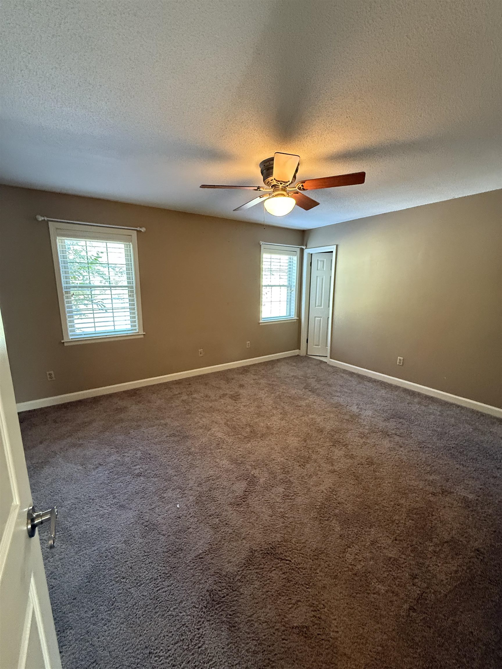 5718 Quince Road, Unit 1 Memphis, TN 38119 - Photo 11 of 17 an empty room with windows and fan