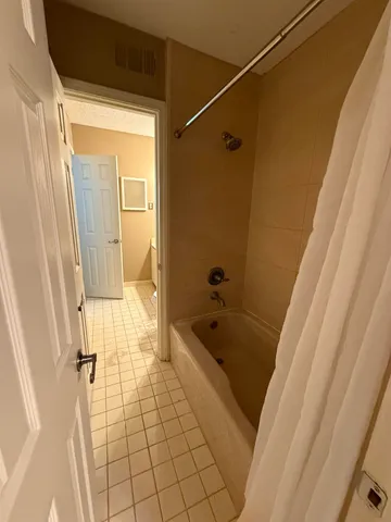 a bathroom with a tub a sink and a shower