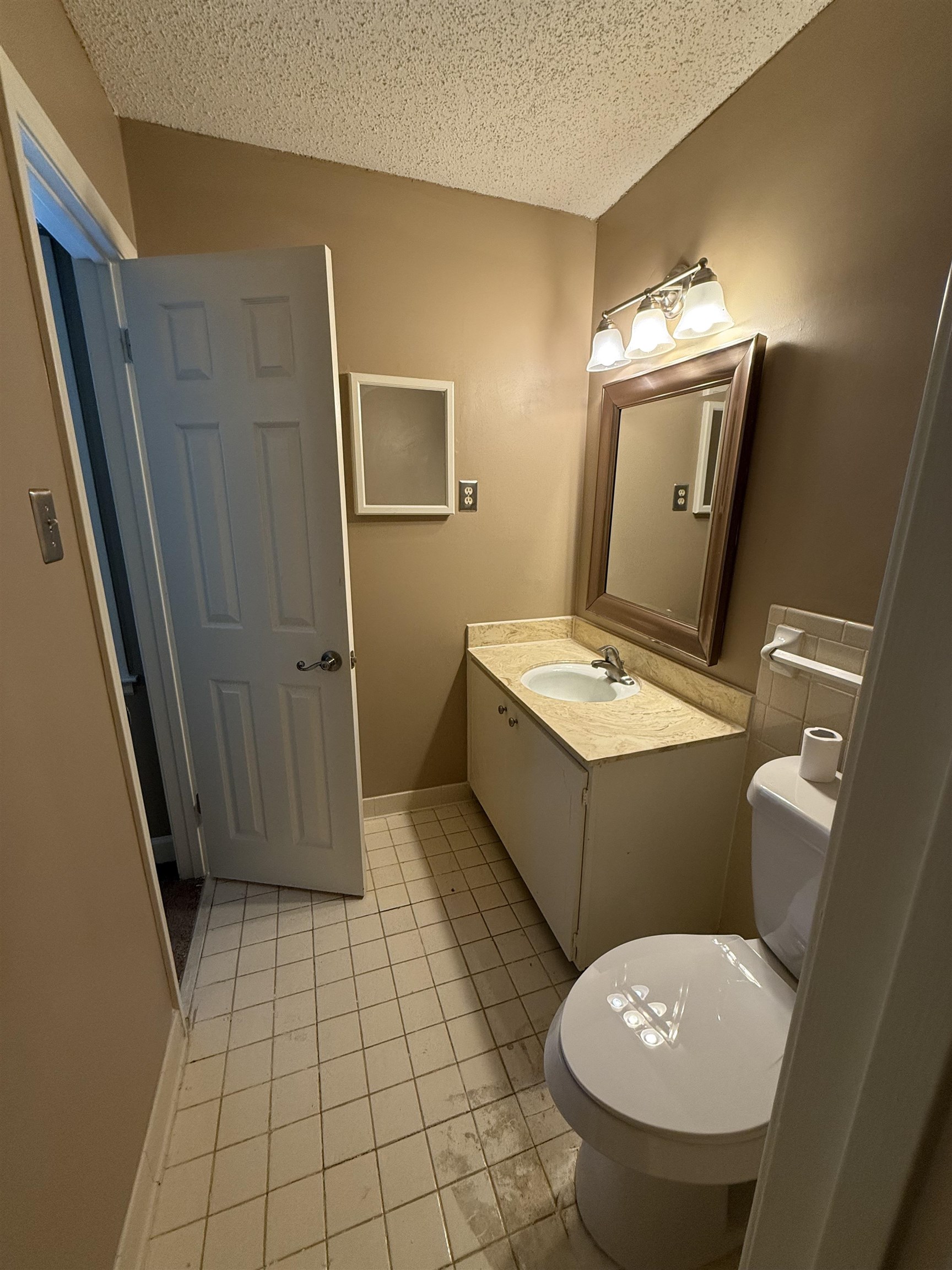 5718 Quince Road, Unit 1 Memphis, TN 38119 - Photo 13 of 17 a bathroom with a toilet mirror and vanity