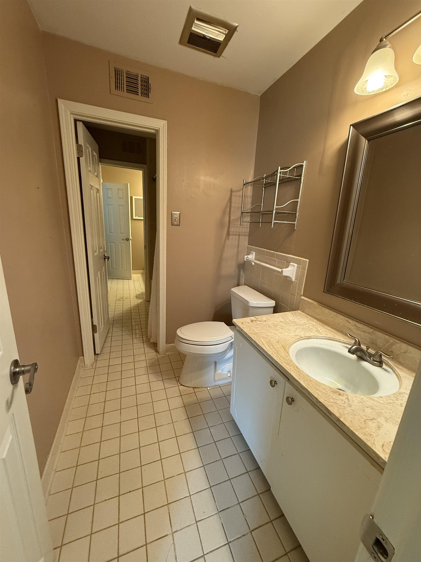 5718 Quince Road, Unit 1 Memphis, TN 38119 - Photo 14 of 17 a bathroom with a granite countertop sink toilet and shower