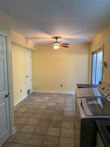 a view of a kitchen with a sink dishwasher a refrigerator and cabinets