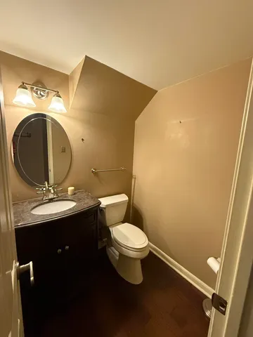a bathroom with a toilet sink and mirror