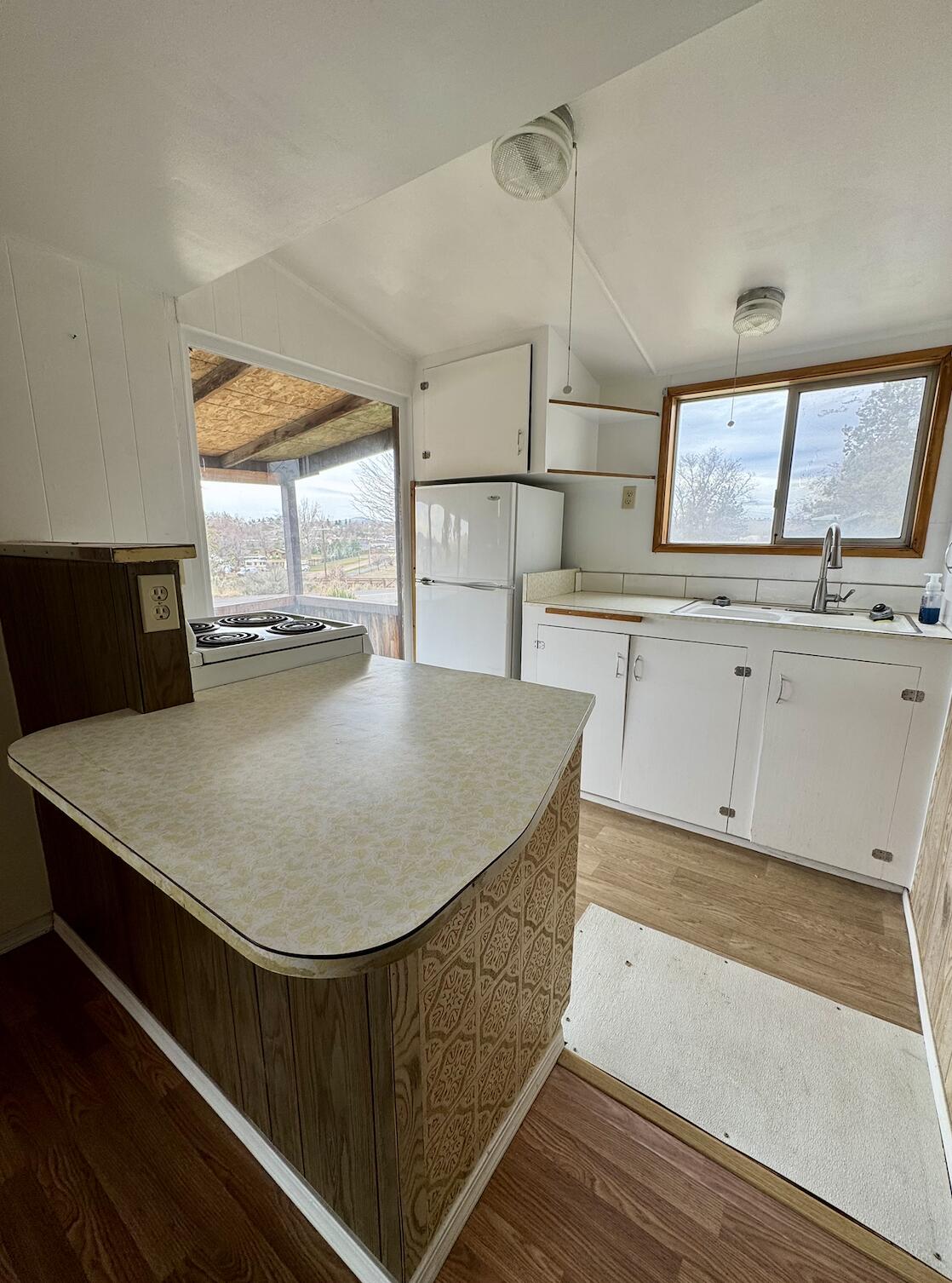 729 Southeast Grizzly Road Madras, OR 97741 - Photo 6 of 14 a kitchen with a stove a counter space and a sink