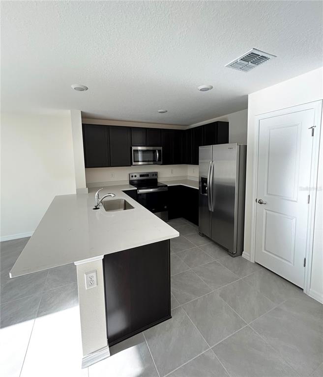 6582 South W 81st Loop Ocala, FL 34476 - Photo 2 of 12 a kitchen with stainless steel appliances a refrigerator a stove a sink and a refrigerator