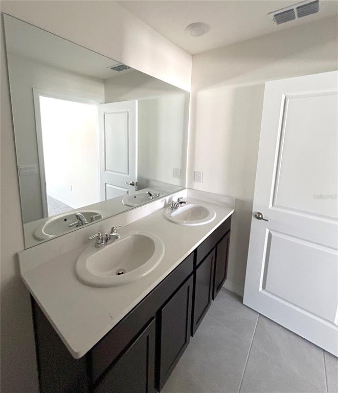 6582 South W 81st Loop Ocala, FL 34476 - Photo 5 of 12 a bathroom with a sink and a mirror