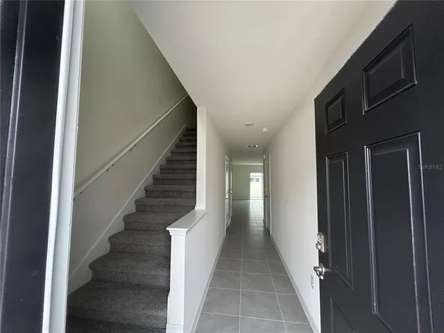 a view of a hallway with staircase