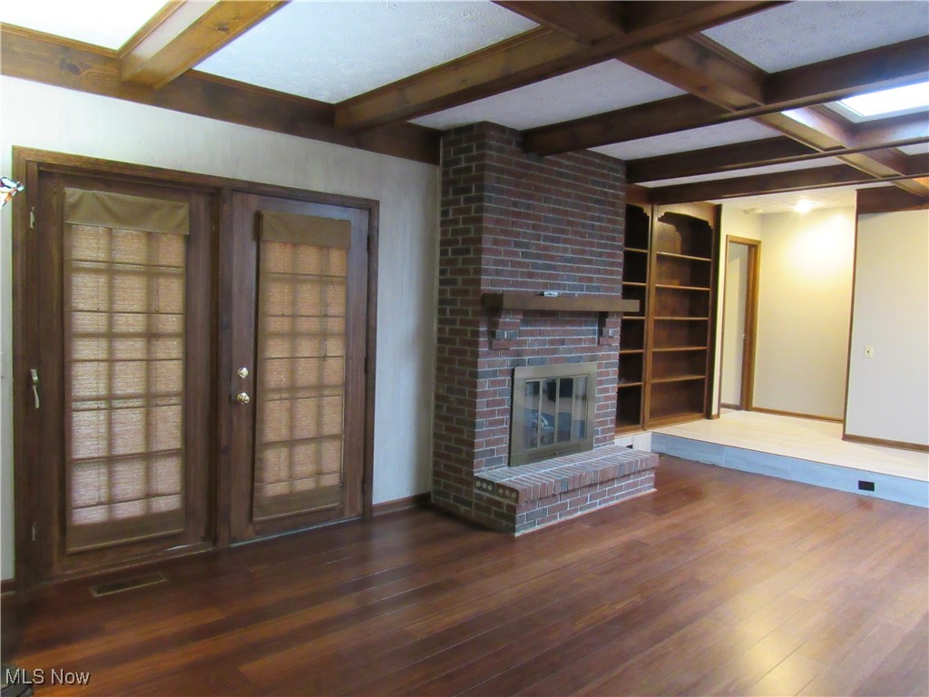 1120 Vincent Road Southeast North Canton, OH 44720 - Photo 22 of 50 Great Room with coffered ceiling, built-in bookcase, bamboo flooring, leading to landing.