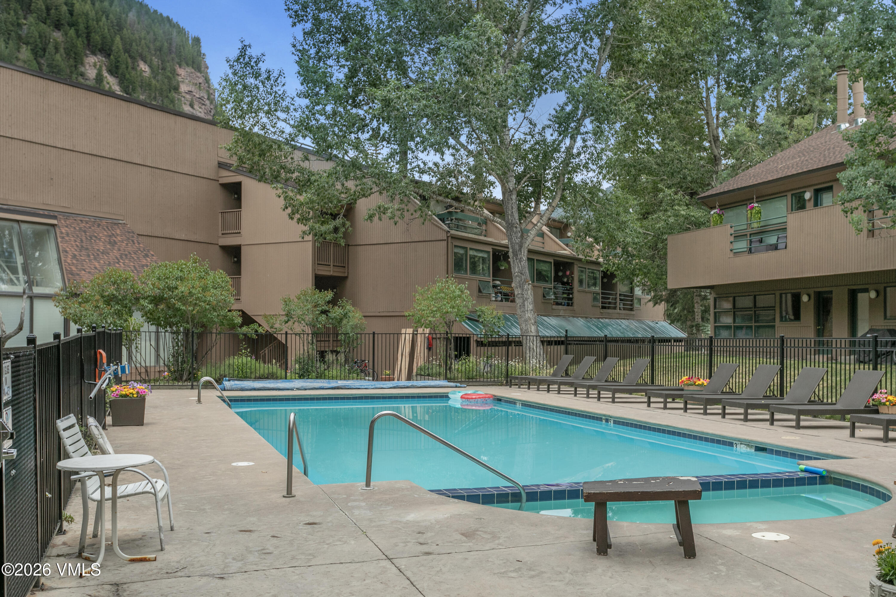 3911 Big Horn Road, Unit 1B Vail, CO 81657 - Photo 26 of 29 a swimming pool with outdoor seating and yard