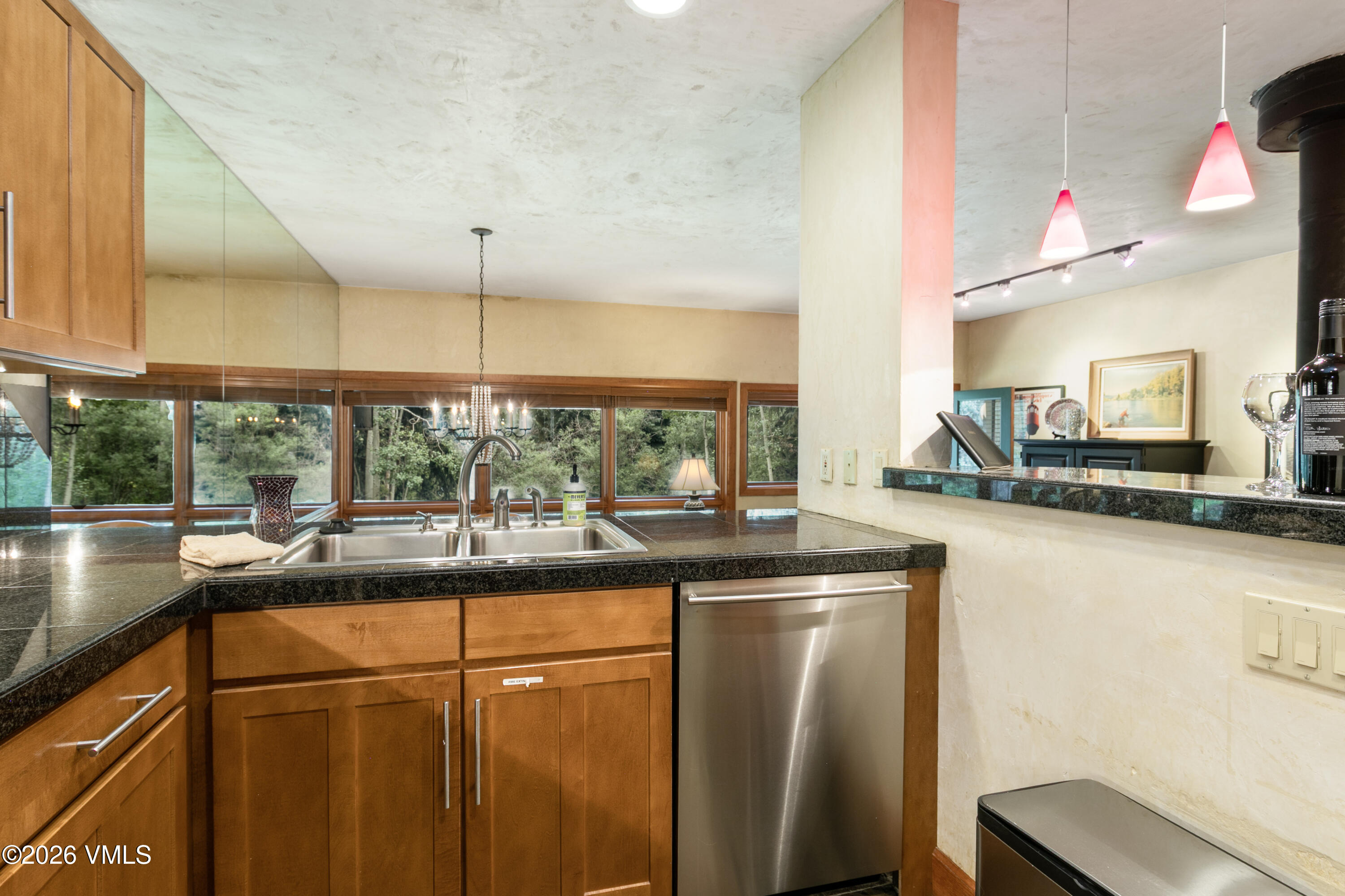 3911 Big Horn Road, Unit 1B Vail, CO 81657 - Photo 4 of 29 a kitchen with stainless steel appliances granite countertop a sink and a microwave