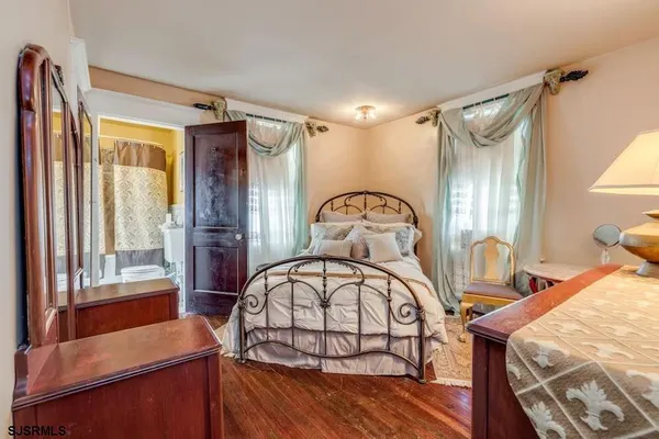 a bedroom with a bed couch and window