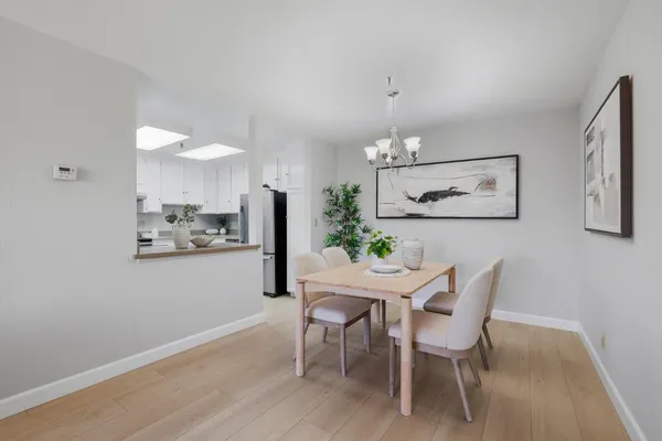 a view of a dining room with furniture and chandelier