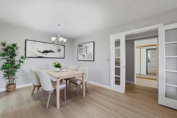 a view of a dining room with furniture and wooden floor