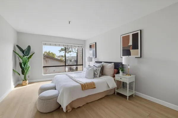 a bedroom with a bed and a window