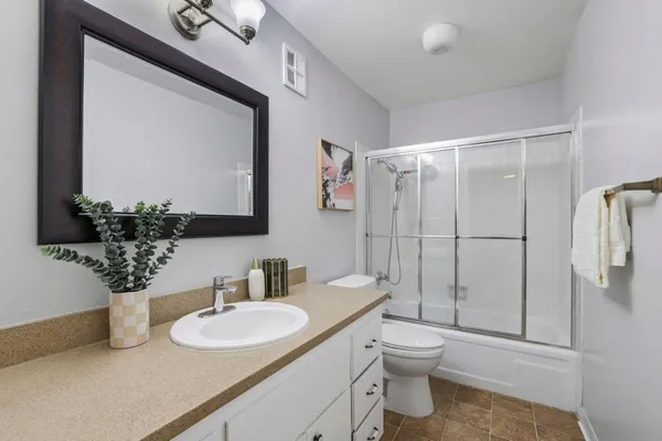 a bathroom with a toilet sink and shower
