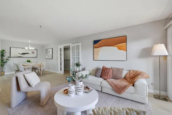 a living room with furniture and a wooden floor