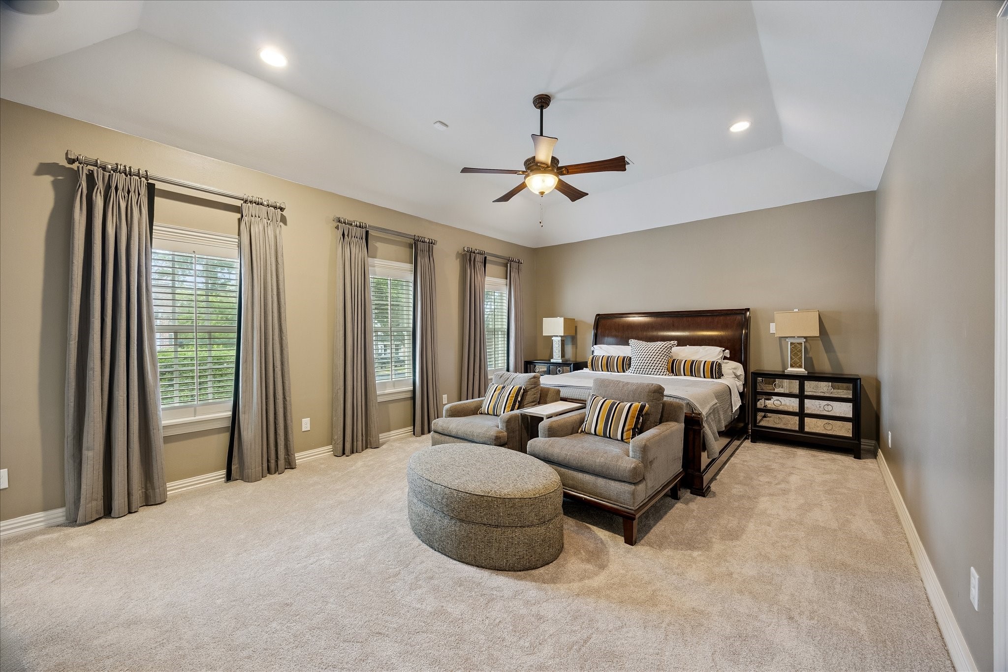 6358 Auden Street Houston, TX 77005 - Photo 22 of 50 a bedroom with a large bed and a chandelier