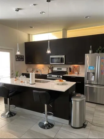 a kitchen with a sink cabinets and stainless steel appliances