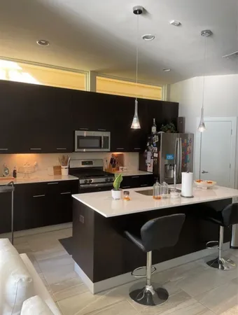 a kitchen with a sink cabinets and wooden floor