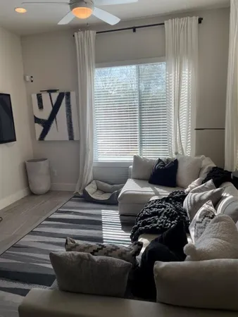 a living room with furniture and a large window